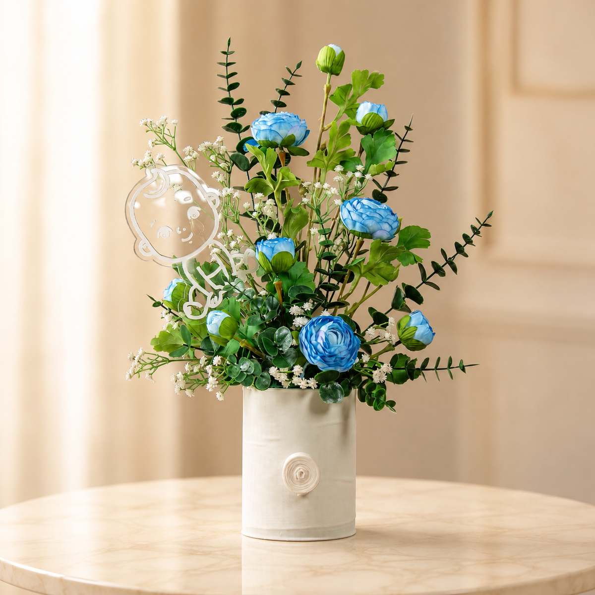 Little Prince – blue ranunculus and eucalyptus newborn baby boy arrangement in a white ribbed vase with an acrylic baby plaque