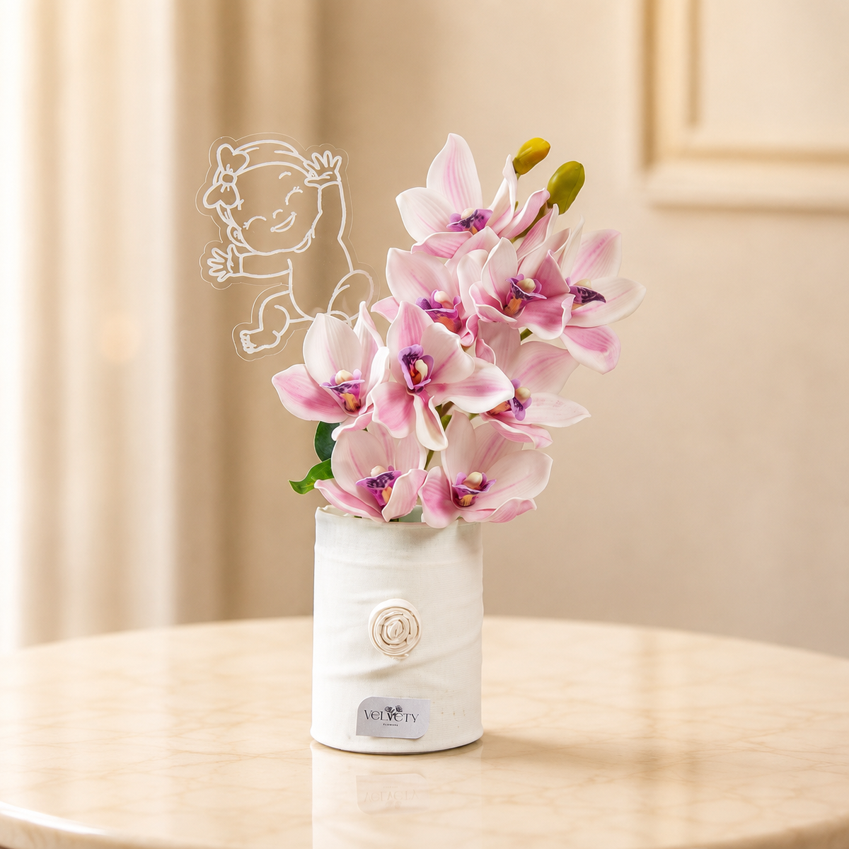 Little Princess – pink cymbidium orchids in a white ribbed vase with an acrylic baby girl plaque