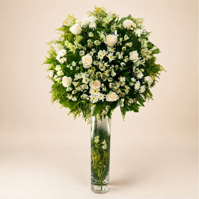 Majestic Elegance Stand - grand white and green floral arrangement in tall glass cylinder vase on clean beige background