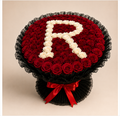 R Letter Rose Bouquet - 120 red and ivory roses forming letter R, black ruffled wrap, red bow, clean beige background