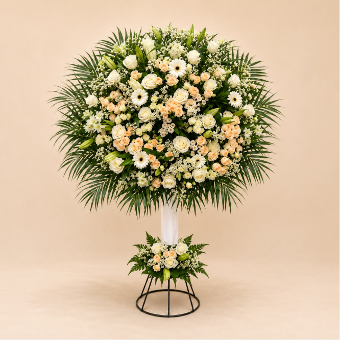 Timeless Grace Stand - ivory rose, peach spray rose, and palm foliage standing arrangement on clean beige background